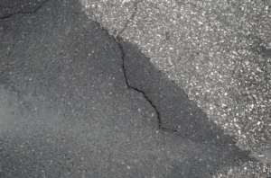 Concrete repair of cracked asphalt surface showing visible damage