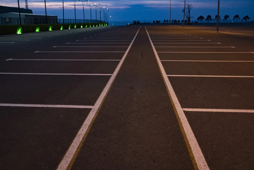 Freshly marked asphalt parking lot at dusk – Parking lot repair