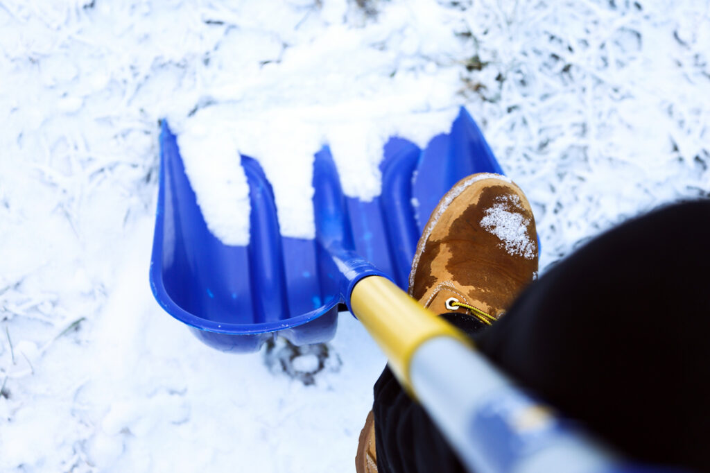 worker doing snow shovelling