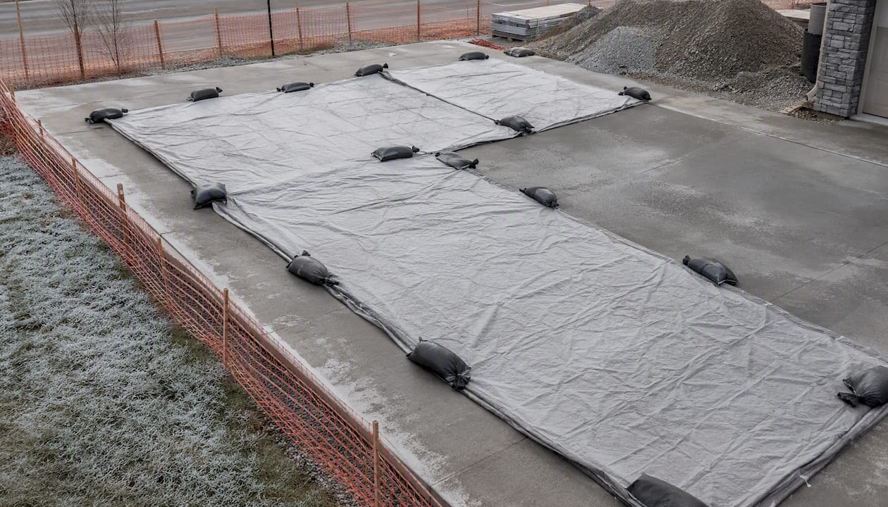 Curing blankets on cold Edmonton residential concrete driveway