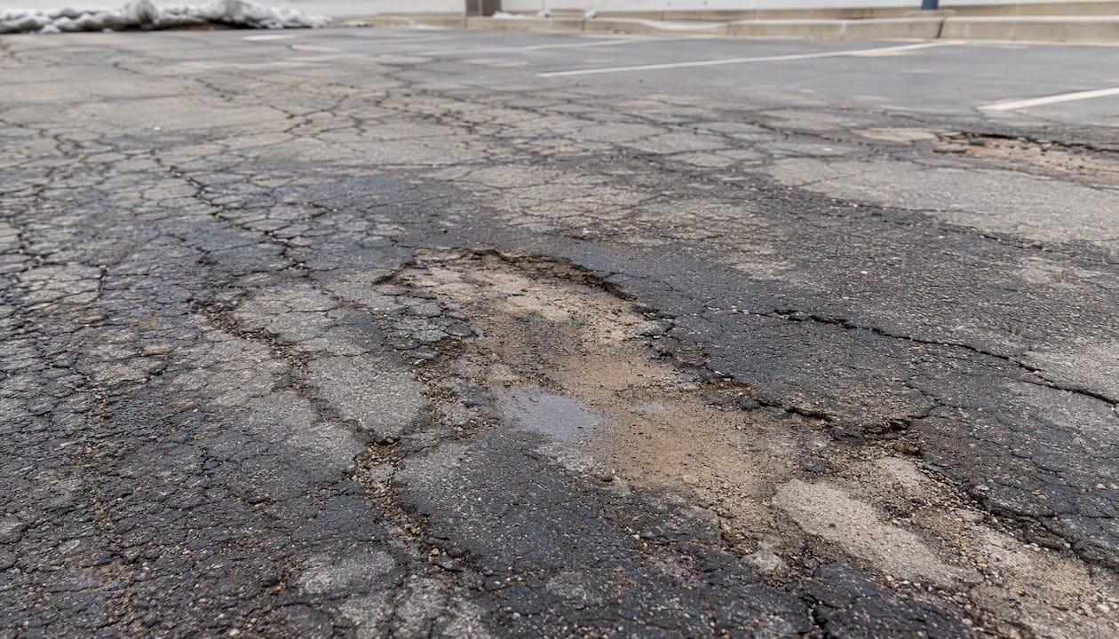 Damaged asphalt surface with recurring alligator cracking