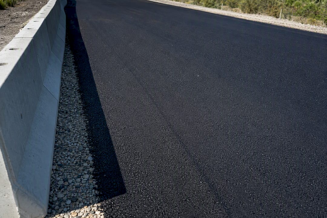 Fresh asphalt pavement reflecting morning light