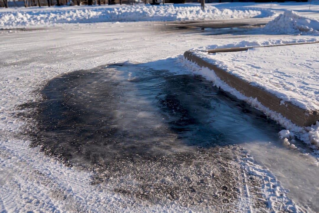 Black ice patch on cleared parking lot