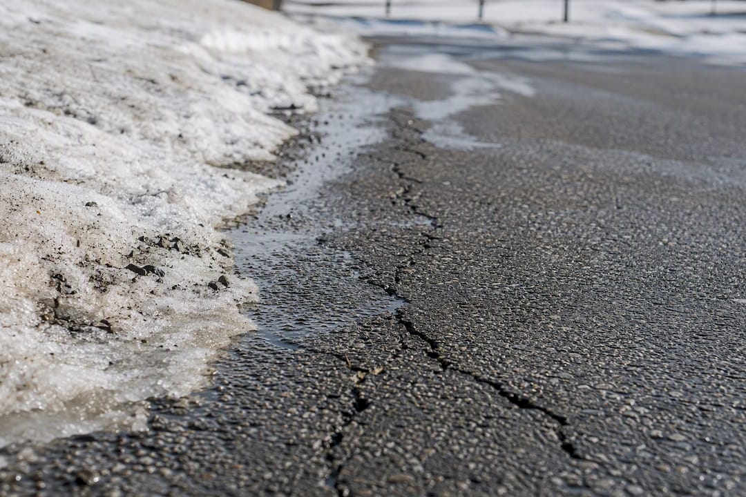 Cracked asphalt surface with freeze-thaw damage