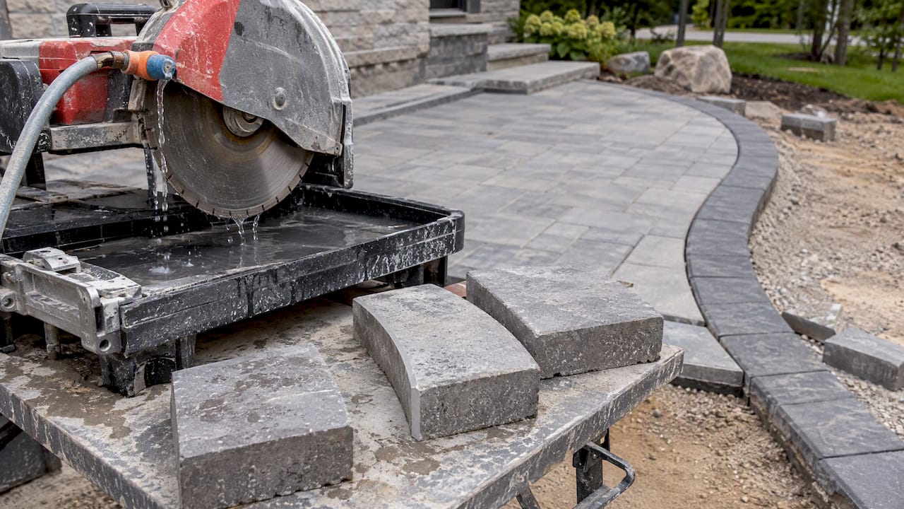 Wet saw beside curved concrete paver cuts